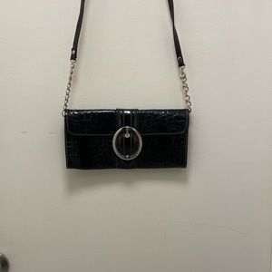 MC black patent leather clutch